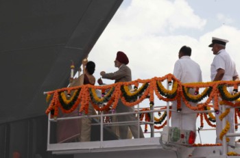 Elizabeth Antony, wife of Defense Minister AK Antony, breaking the coconut, on the Chennai, the third Kolkata-class Destroyer, at Mazagon Docks in Mumbai on Thursday.
