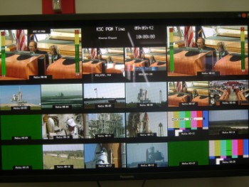 DSC02865 A television set running live feeds from multiple cameras, focusing on the launch pad, shuttle and the astronauts prepping up.