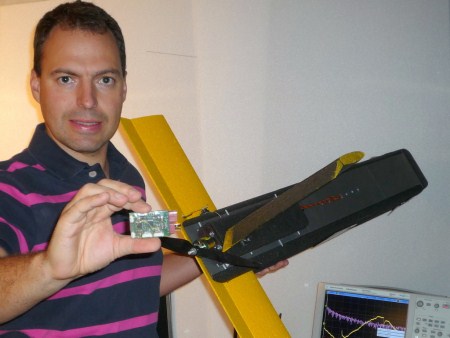 Fabien holds up the navigation board and a UAV.